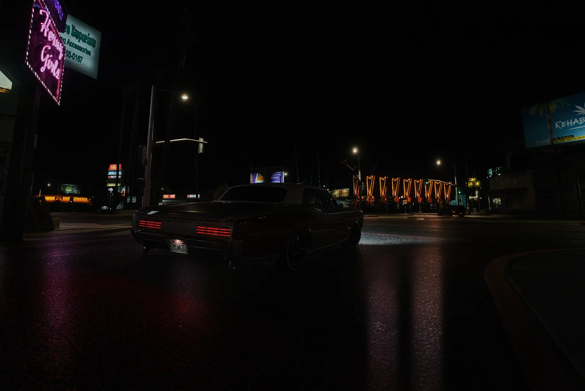 Dark coupe on a wet street under neon